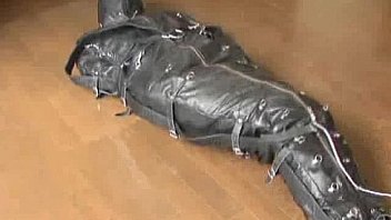 Ballgagged asian girl tied into a leather sleepsack teased and vibed