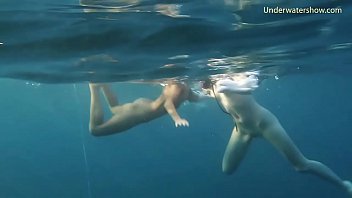 Underwater in the sea young babes swimming nude