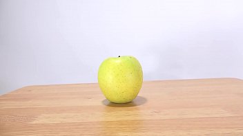 Woman's hand grabs an apple